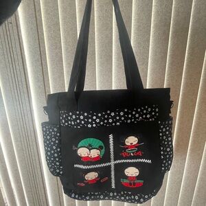 Pics bag with a handle and a strap.